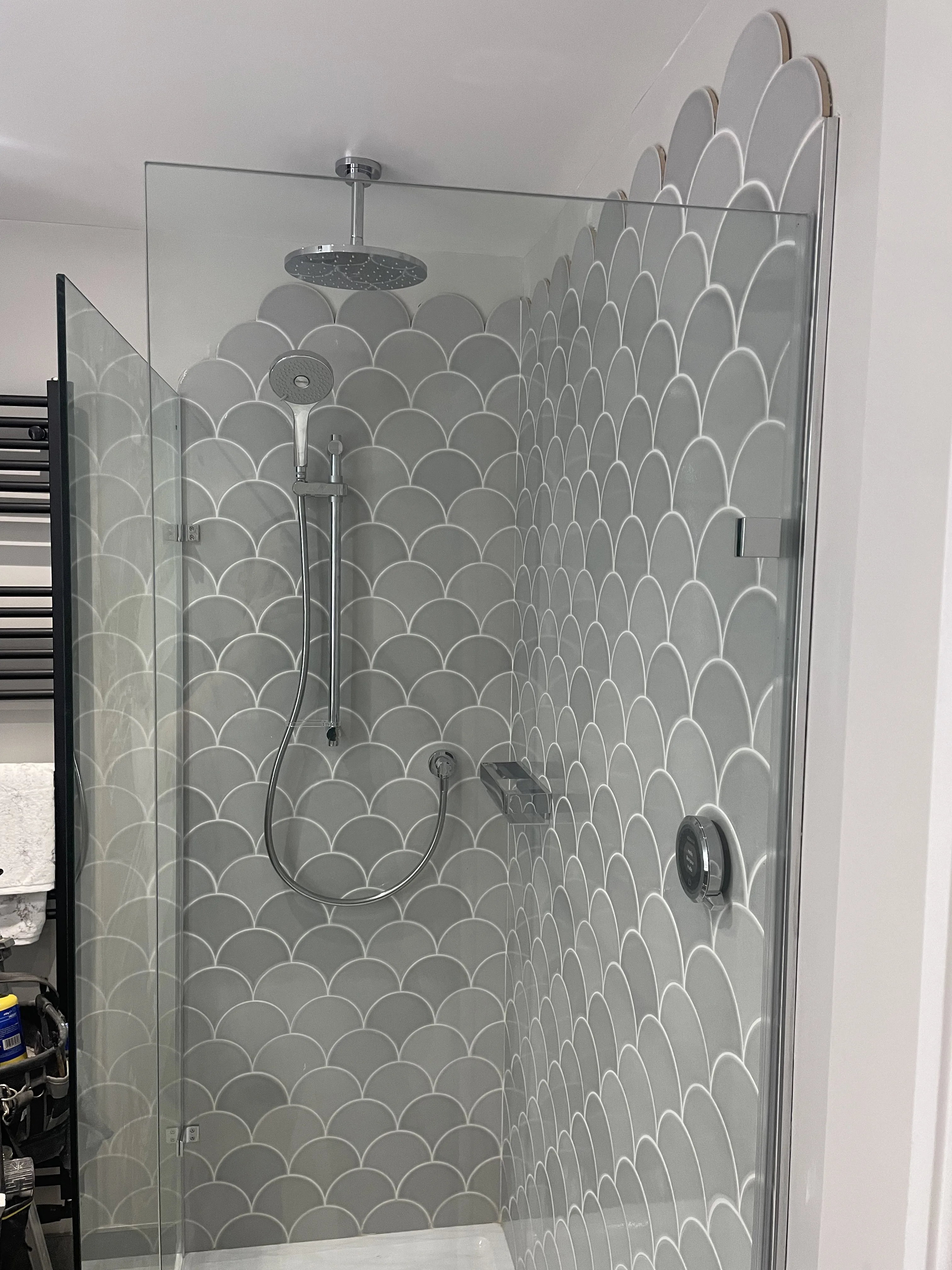 Tiled shower enclosure with glass screen